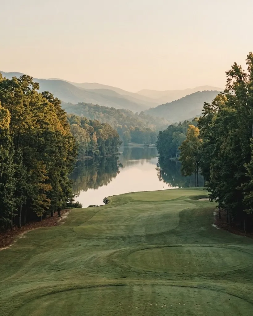 A lakeside golf hole reflected in a quiet cove